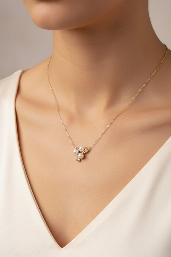 Gold necklace with pearl pendant on a beige background