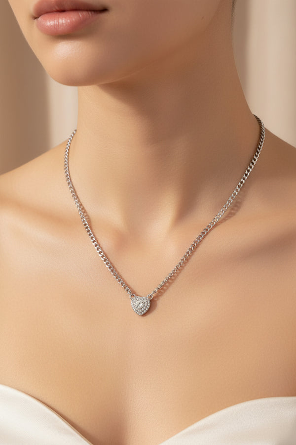 Necklace with heart-shaped clasp on a beige background, showing length measurement.