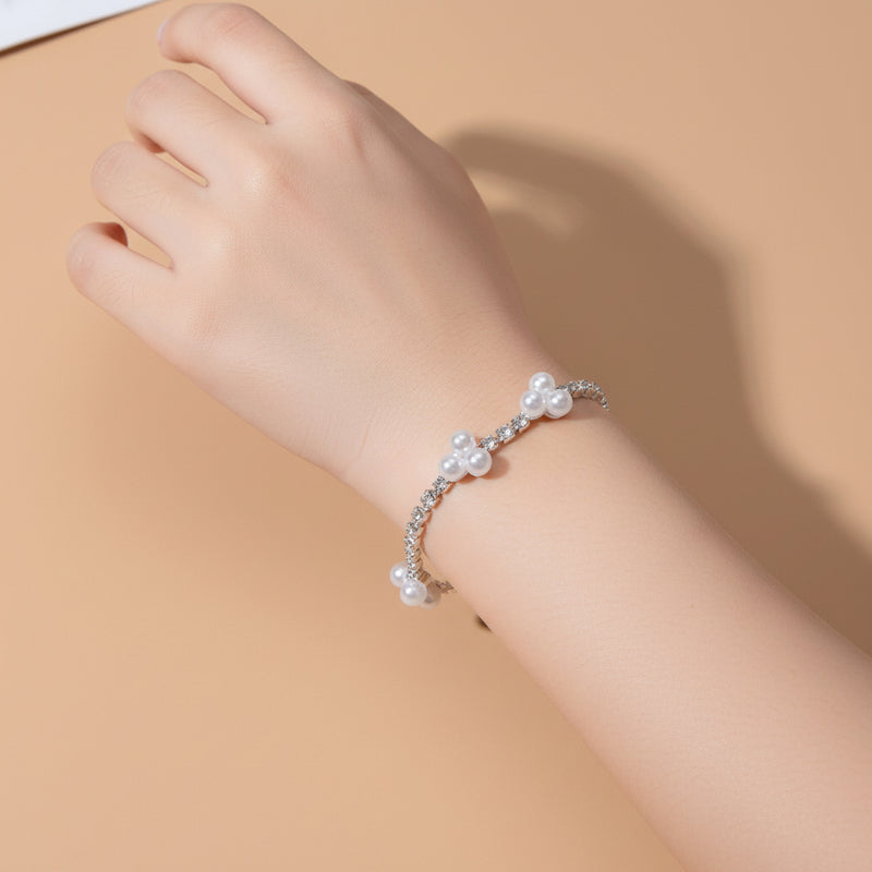 Silver bracelet with pearls on a beige background
