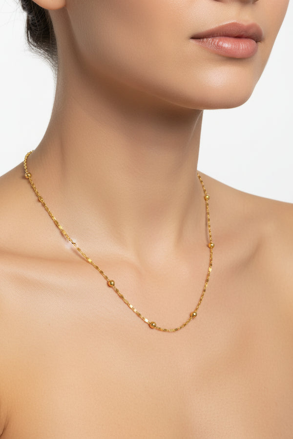 Gold chain necklace on a white background
